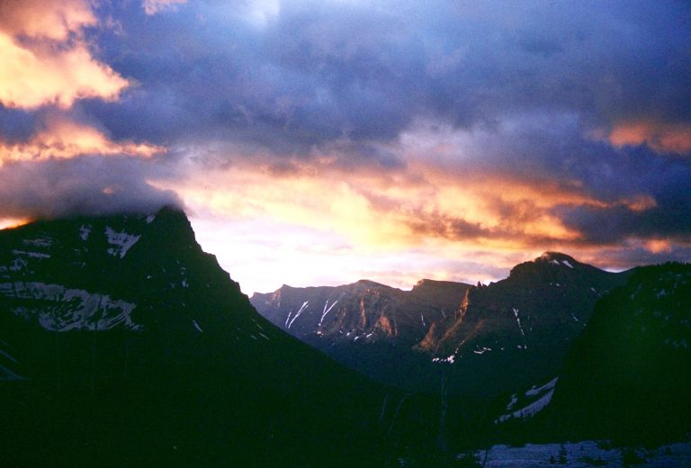 Sunrise colors clouds near Mt Oberlin in Glacier National Park Montana