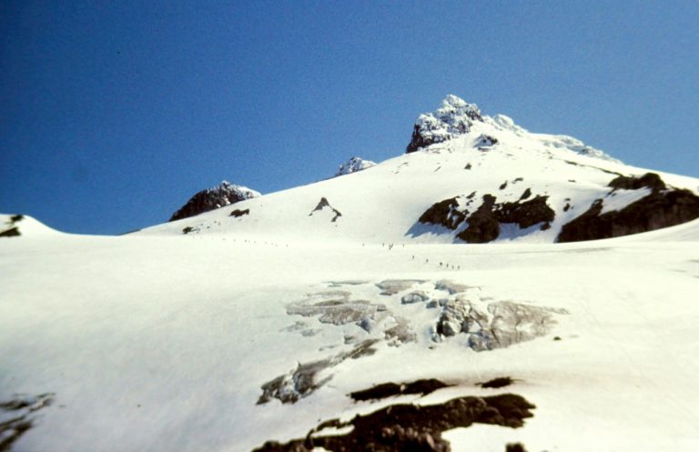 The craggy summit of Glacier Peak rises above the Sitkum Glacier in the North Cascades