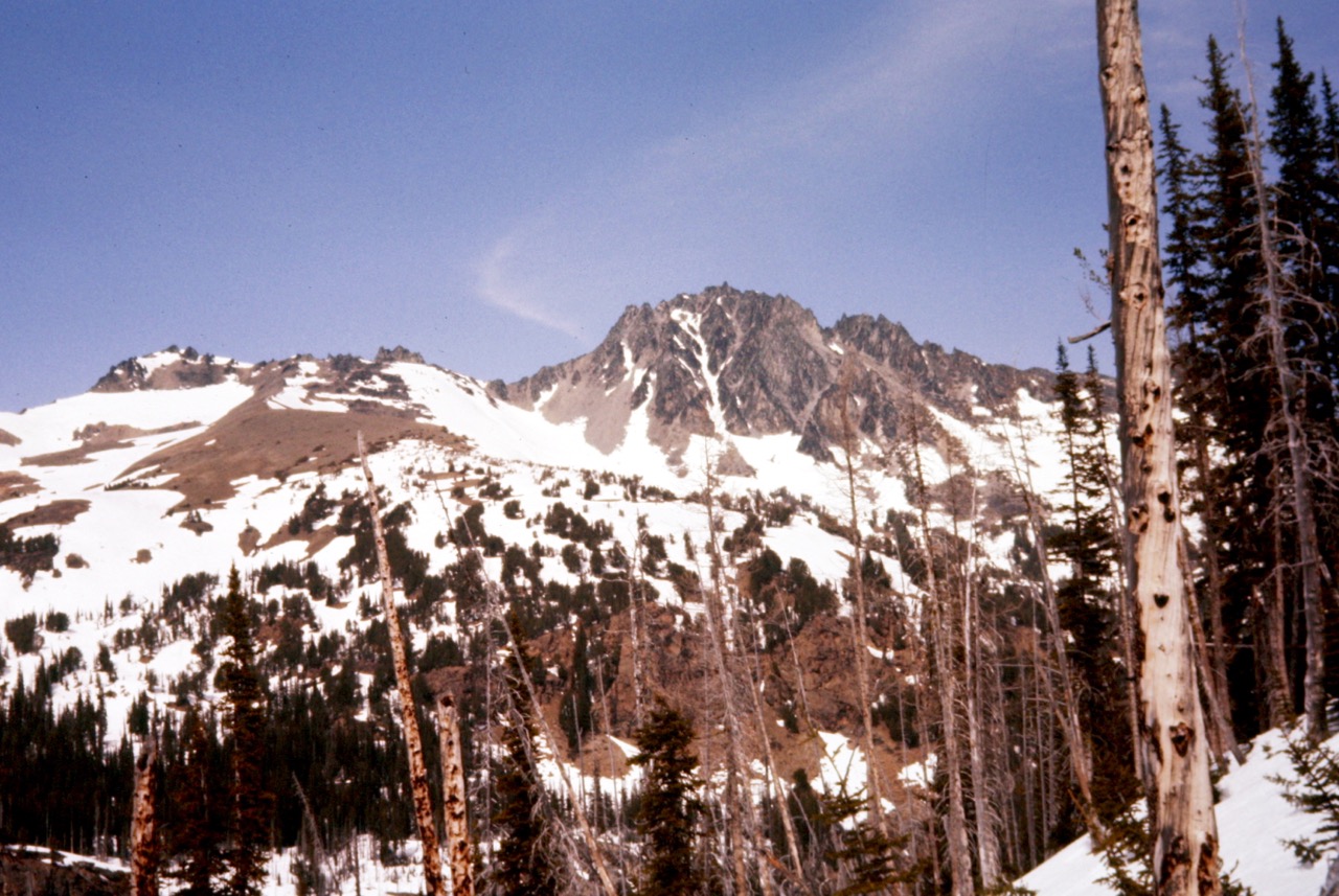 The rocky summit of Cashmere Mountain stands above the snowy slopes of Windy Ridge in the Alpine Lakes Wilderness