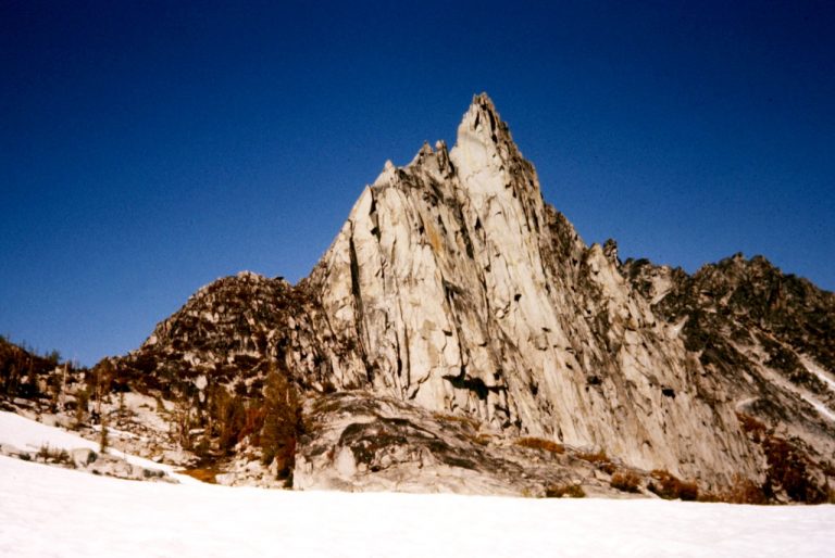 The golden granite spike of Prusik Peak rises above The Enchantments in the Alpine Lakes Wilderness