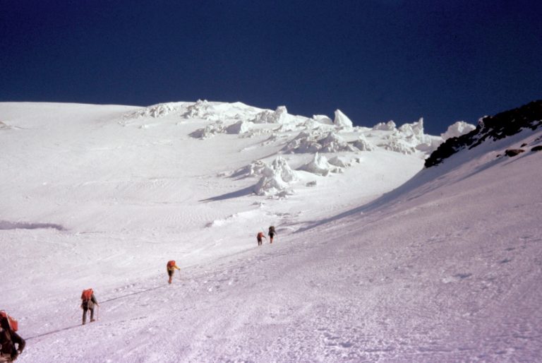 A rope team of mountain climbers ascends the Kautz Glacier high on Mt Rainier