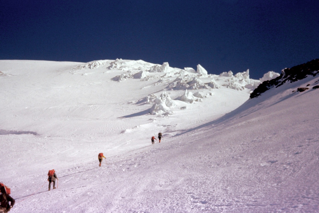 A rope team of mountain climbers ascends the Kautz Glacier high on Mt Rainier