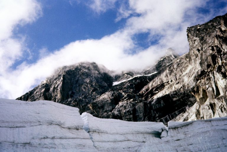 Looking over a vertical ice headwall at the gray cliffs of Mt Stuart in the Stuart Range
