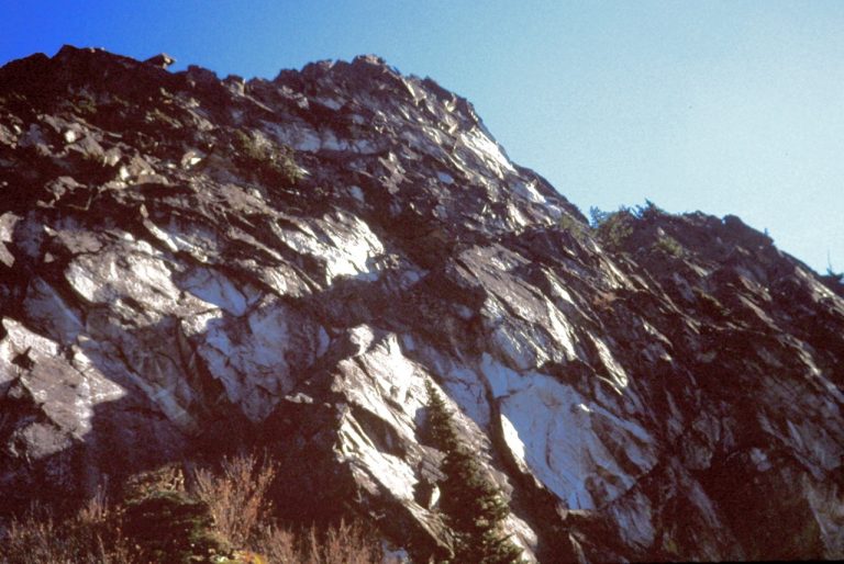 Looking at the steep, gray, rock face of Lichtenberg Mountain near Stevens Pass