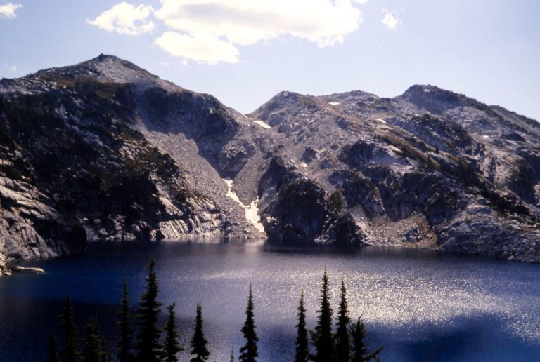 Granite Mountain sits across the shimmering water of Robin Lake in the Cascades