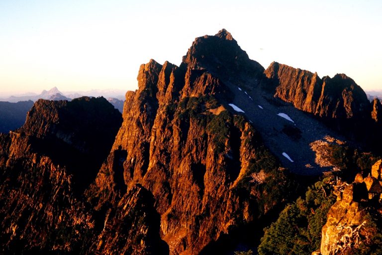 Evening light casts a red glow on Del Campo Peak in the Monte Cristo Mountains as seen from Gothic Peak