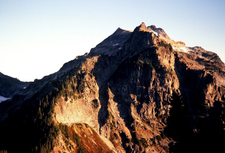 Morning sun warms the cliffy east face of Kyes Peak in the Cascade Range