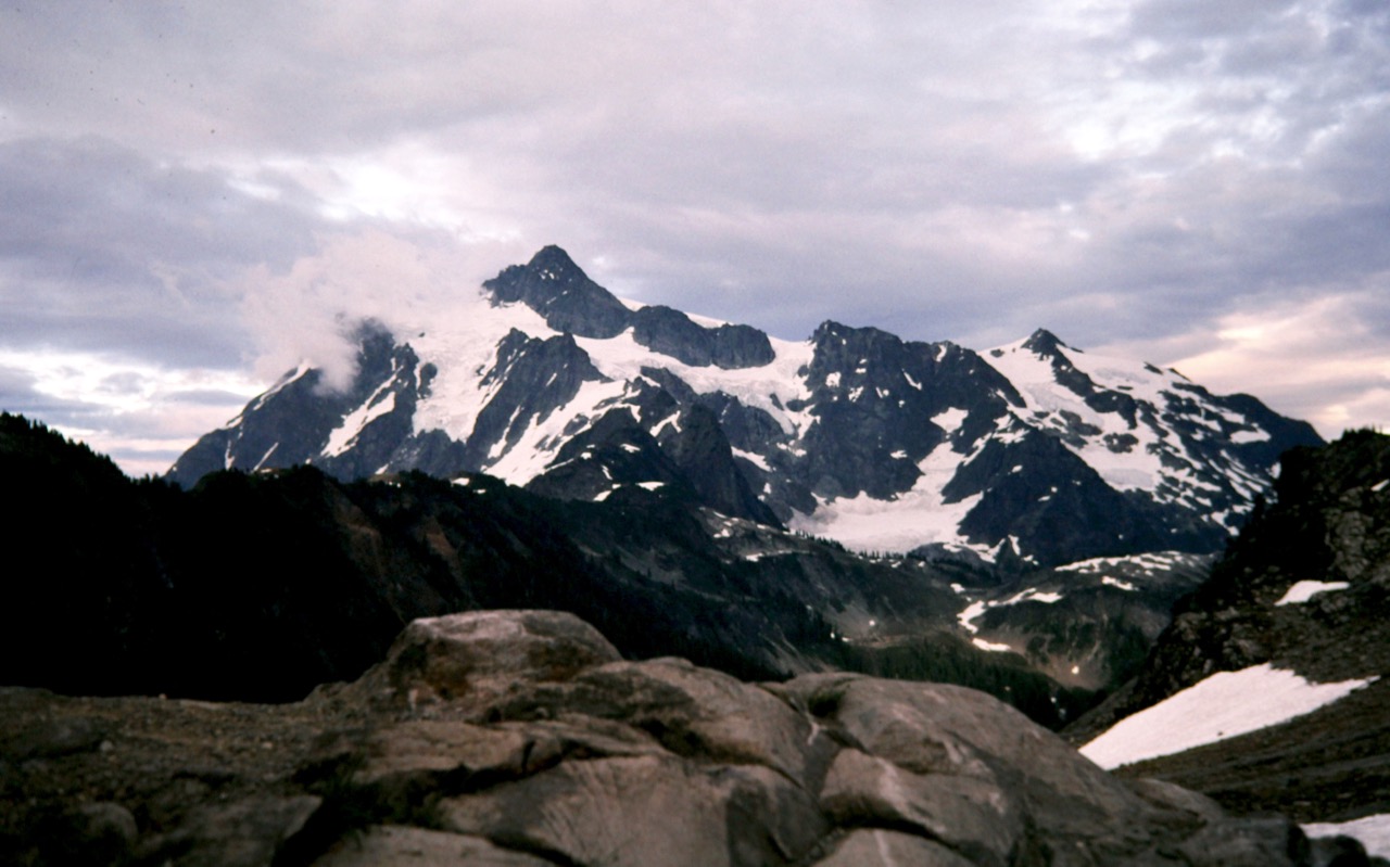 Mt Shuksan stands under a cloudy sky viewed from Artist Point in North Cascades National Park