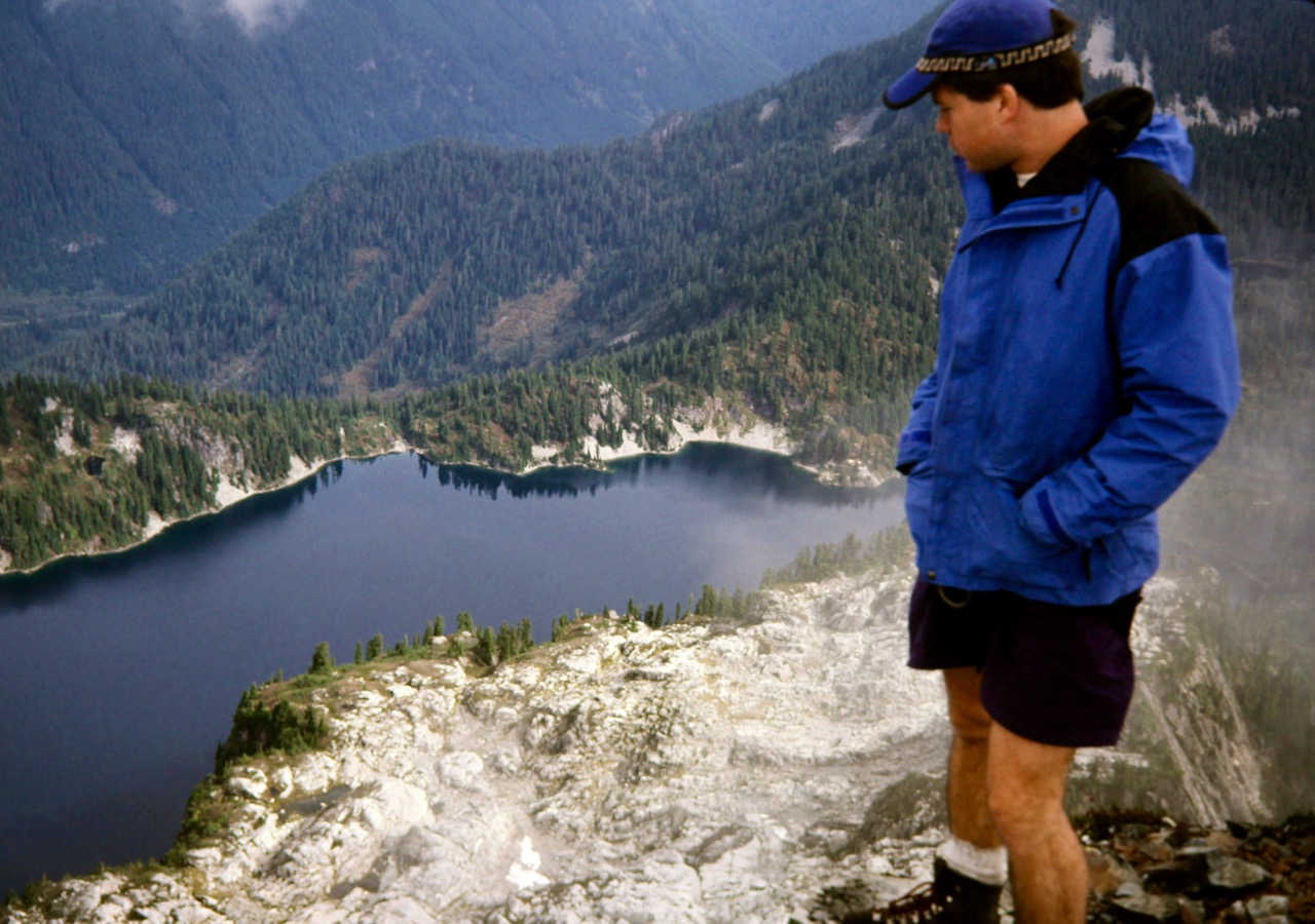 A mountain climber looks down on Snow Lake from summit of Chair Peak in the Snoqualmie Mountains