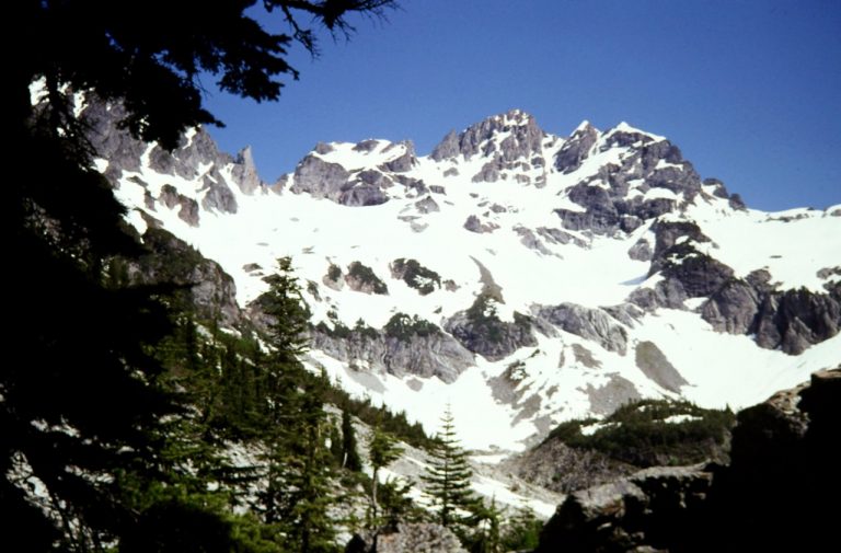 Snow-covered Monte Cristo Peak stands above Glacier Basin