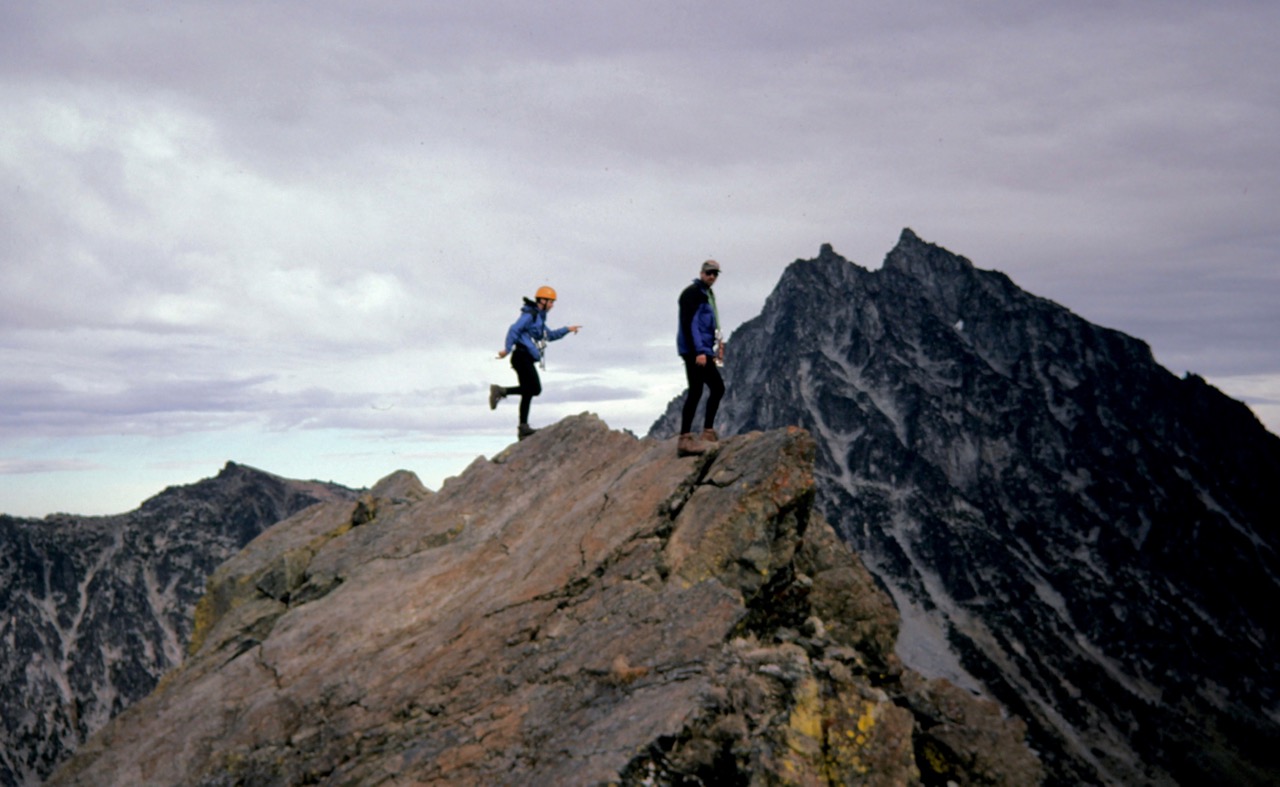 Mountain climbers stand atop North Ingalls Peak in front of Mt Stuart