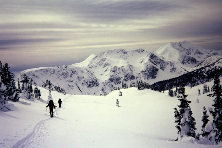 Two Backcountry Skiers Crossing Snow Slope during the Trophy--Table Ski Traverse in Wells Gray Provincial Park in the Cariboo Mountains