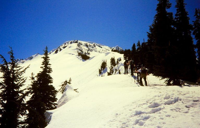 Snowshoers Hiking Up Snowy North Ridge Toward Jim Hill Mountain near Stevens Pass