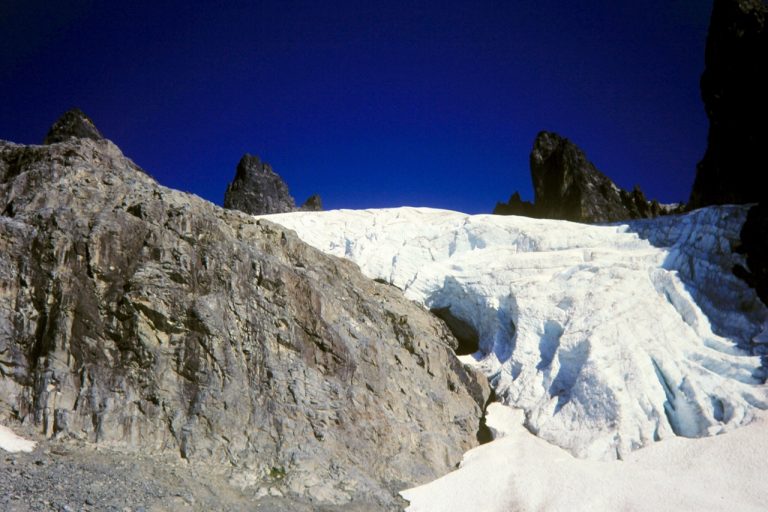 The rocky pinnacles of Chimney Rock stand over the heavily crevassed Chimney Glacier