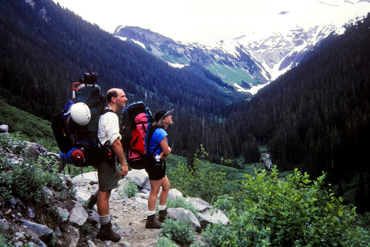 Two backpackers stop to rest on trail to Hannegan Pass on the way to Easy Peak in the Northern Pickets