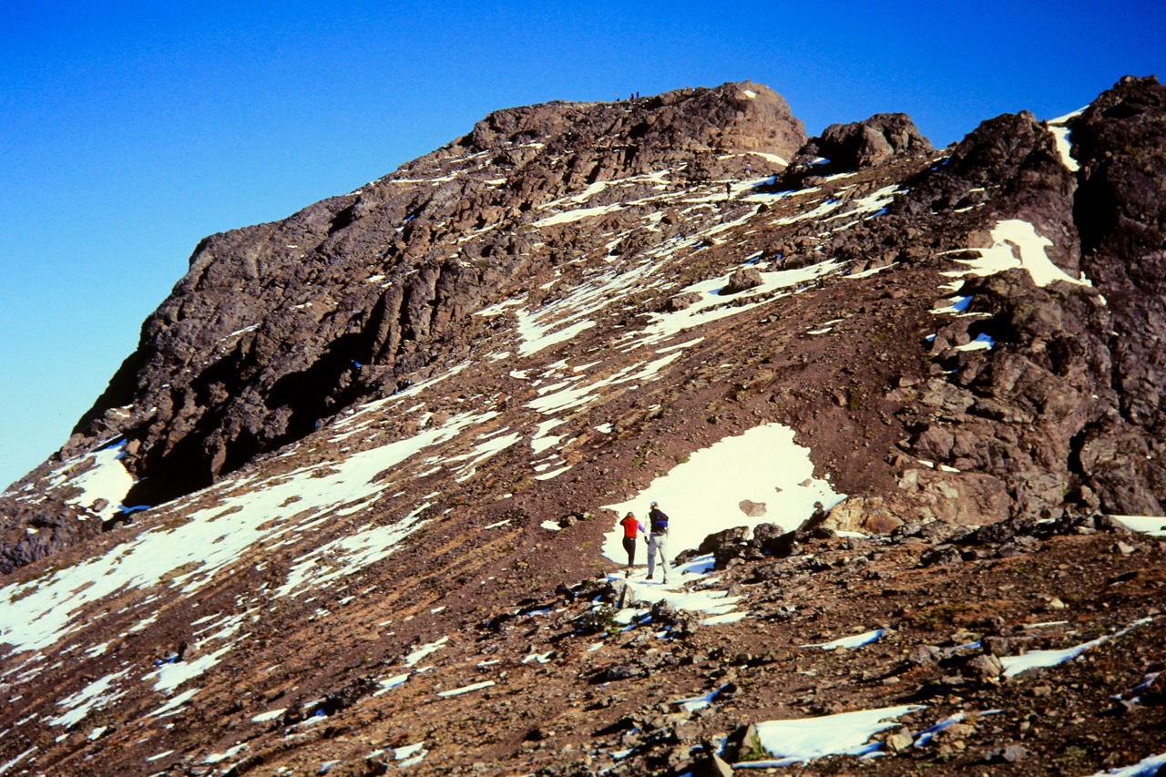 Two hikers follow a high trail to summit of Crater Mtn
