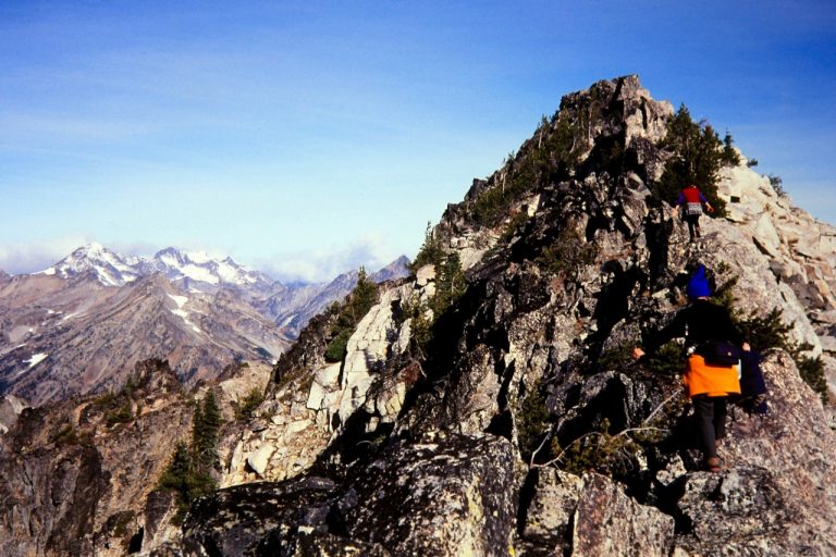 Climbers scramble up the rocky ridge of Fifth of July Mtn