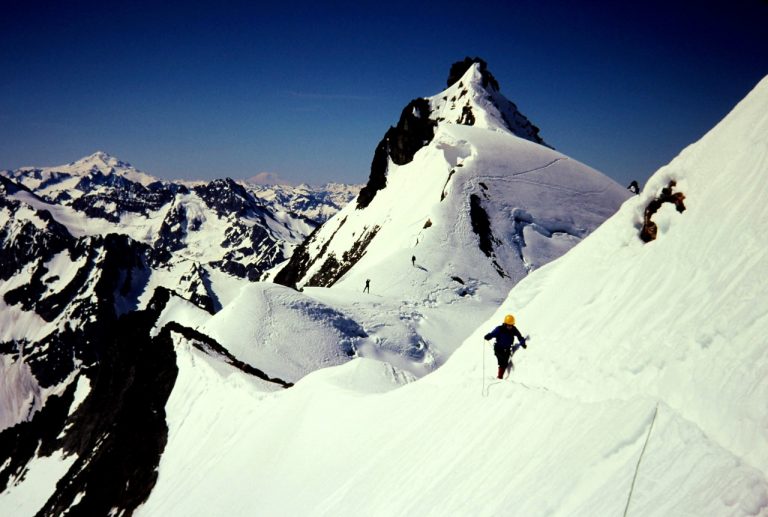 A climber traverses very steep snow on east face of Boston Peak