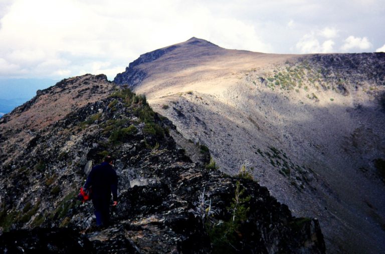 Three climbers scrambling along a rocky ridge on Big Jim Mtn
