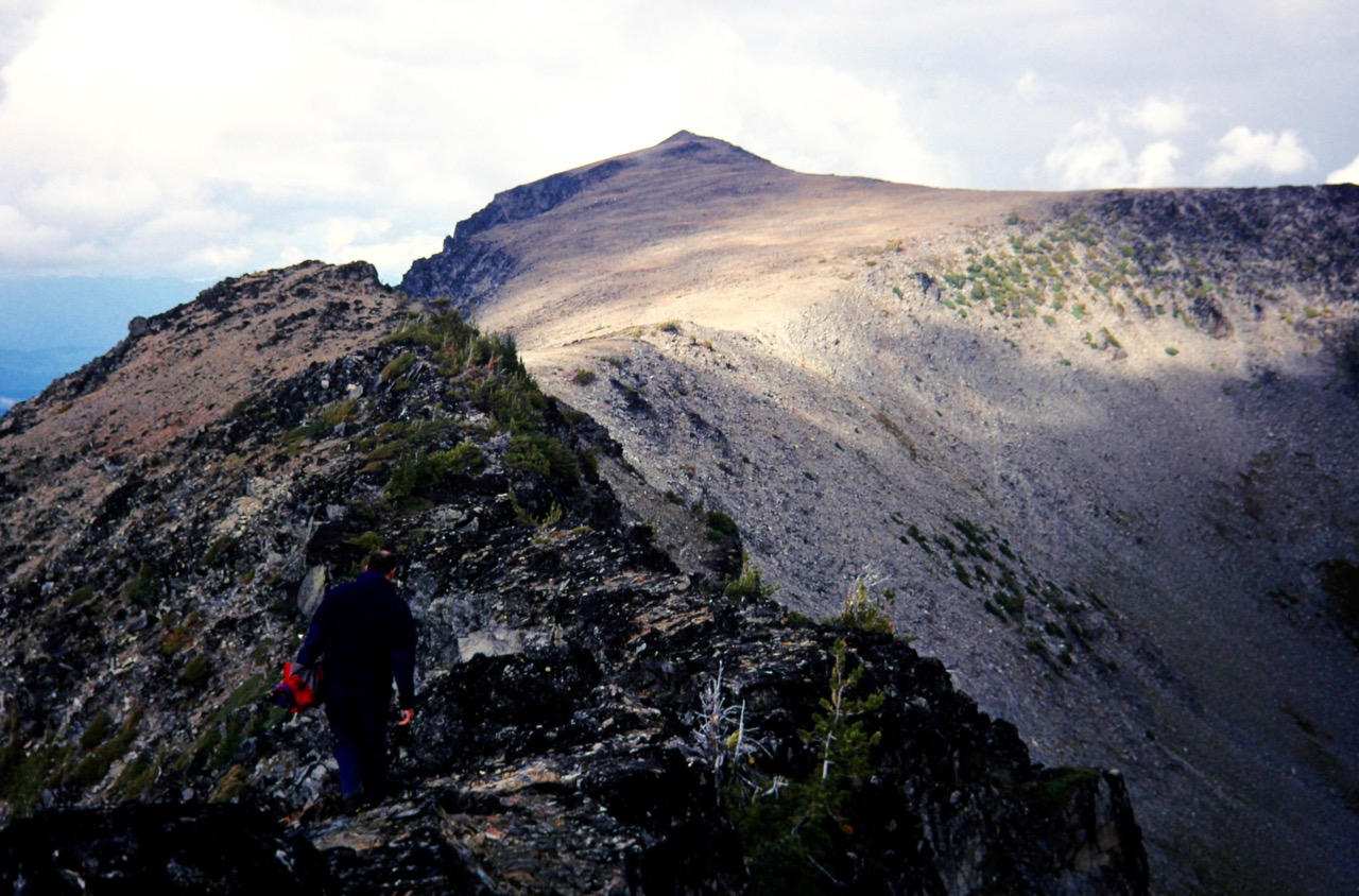 Three climbers scrambling along a rocky ridge on Big Jim Mtn