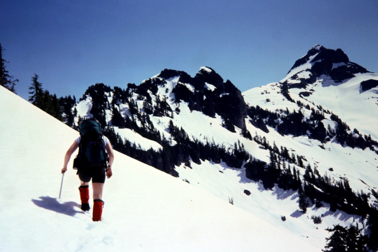 A solo climber hikes through deep snow toward Mt Chaval