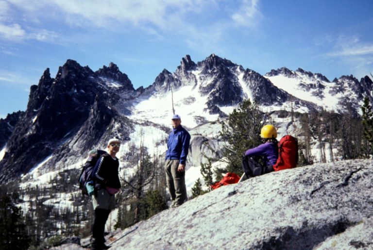Rock climbers take a rest stop on a rock slab below the Enchantment Temple