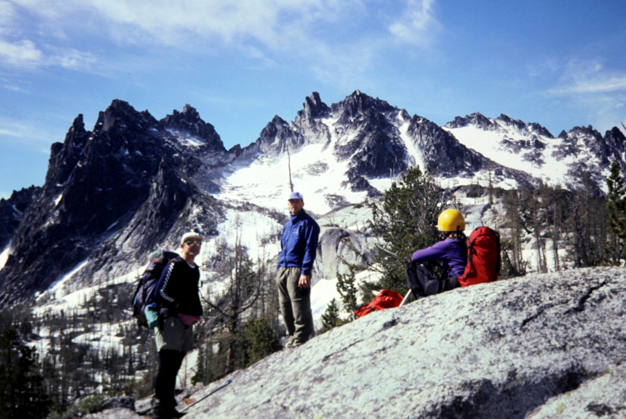 Rock climbers take a rest stop on a rock slab below the Enchantment Temple