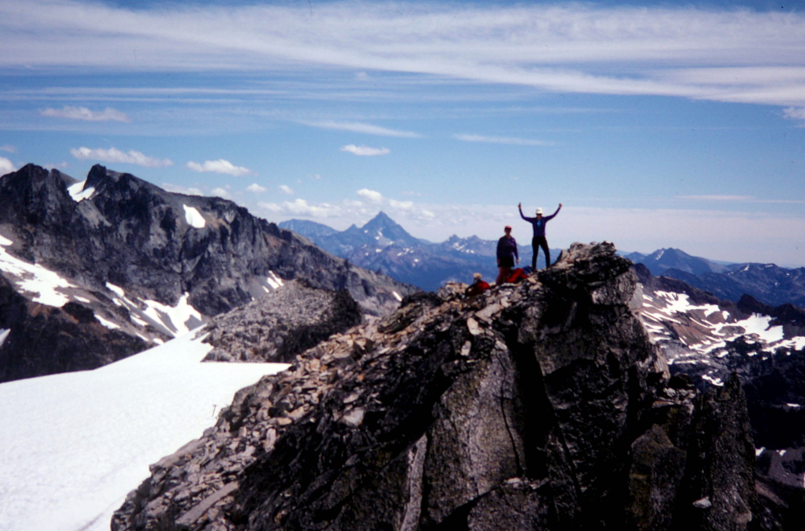 Two mountain climbers stand atop Mt Hinman in the Snoqualmie Mountains