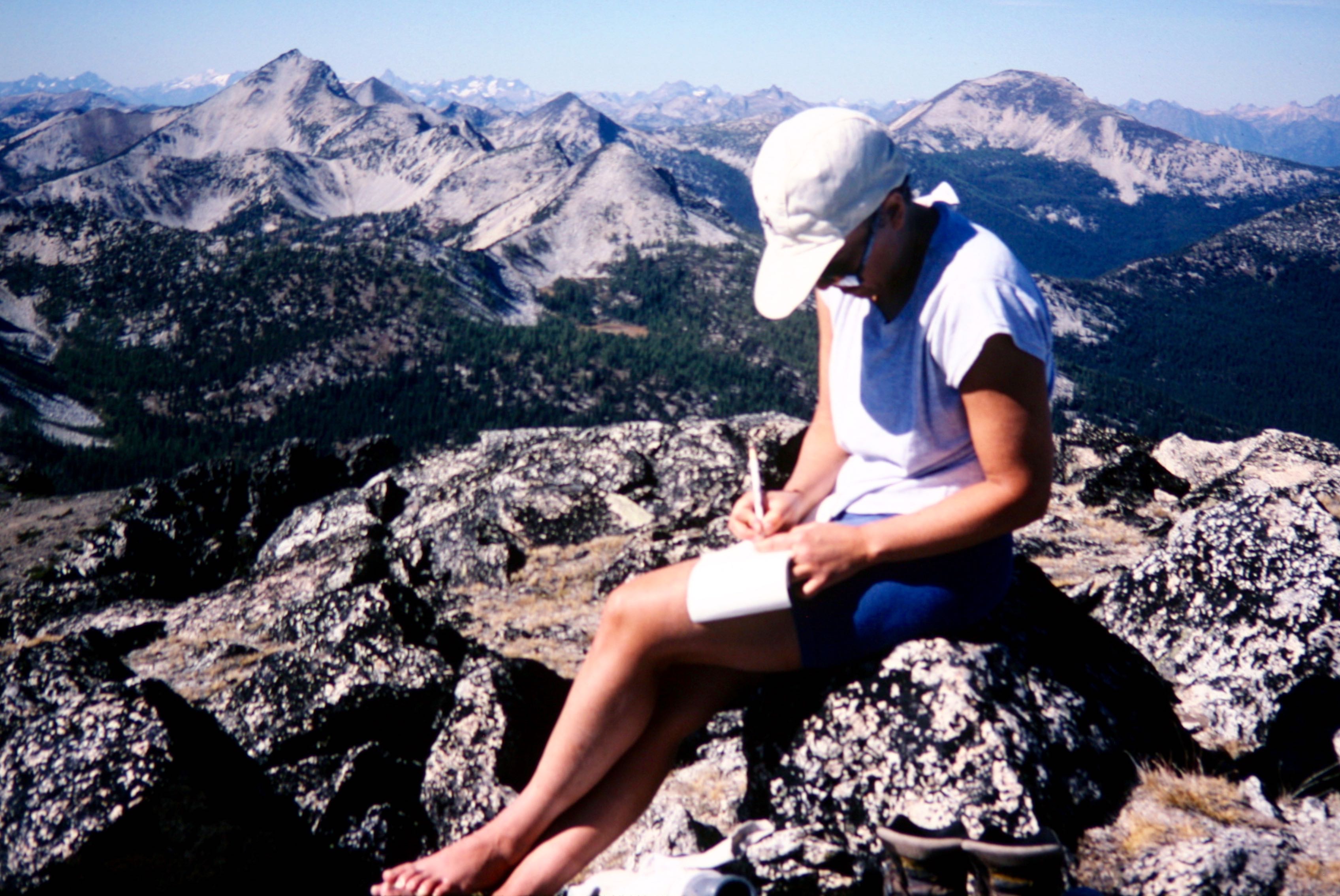A mountain climbers signs a summit register on Mt Bigelow in the Sawtooth Mountains