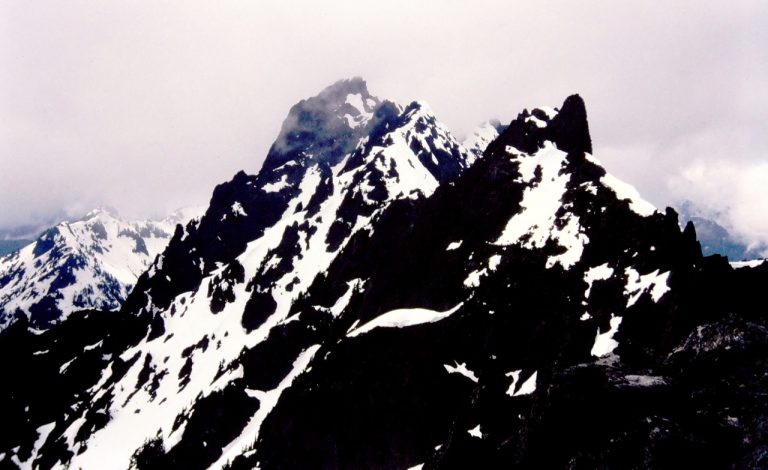 Three black rock peaks stand in a row on Addison Ridge from Little Pirate Peak