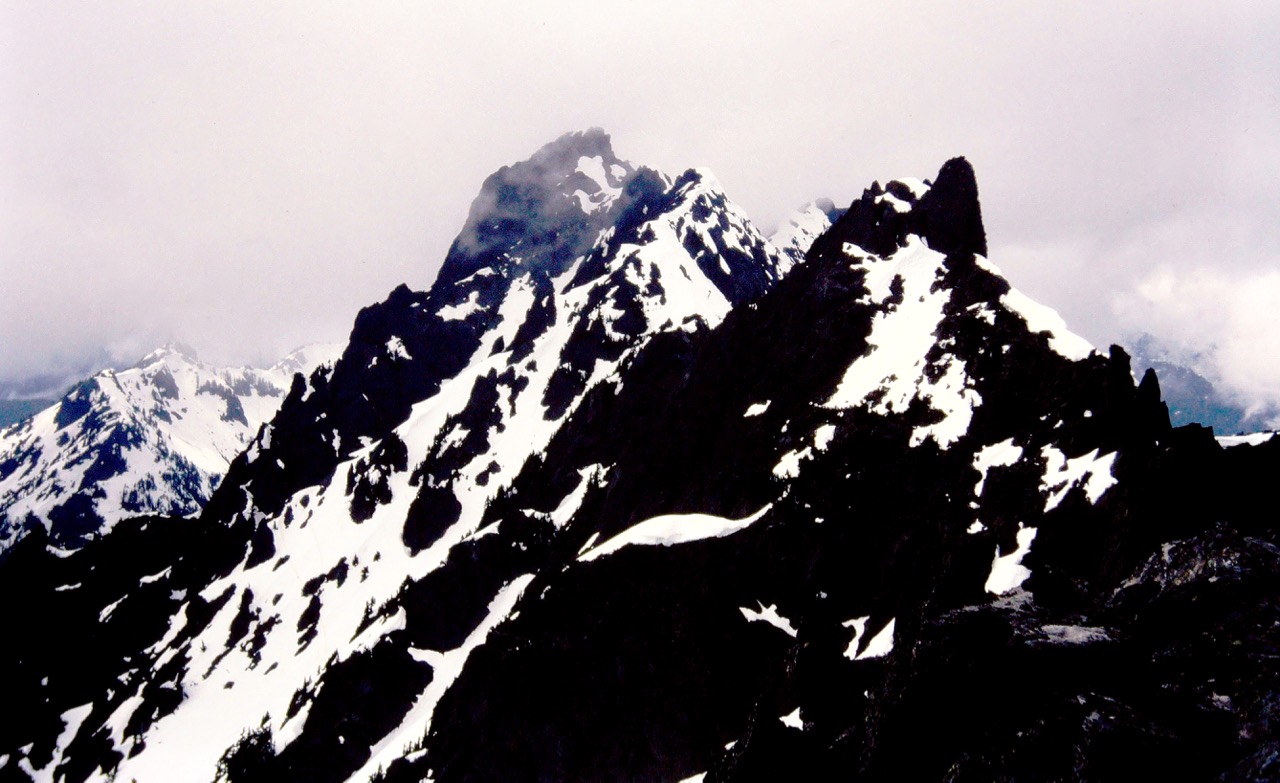 Three black rock peaks stand in a row on Addison Ridge from Little Pirate Peak