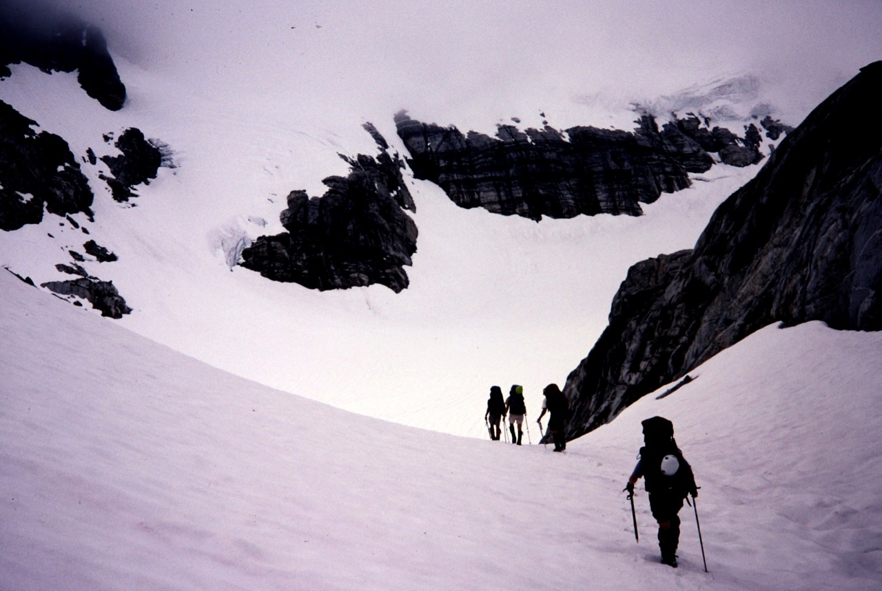 mountain climbers booting up snow filed basin on the way to Borealis Pass marking the start of the Inspiration Traverse in the North Cascades