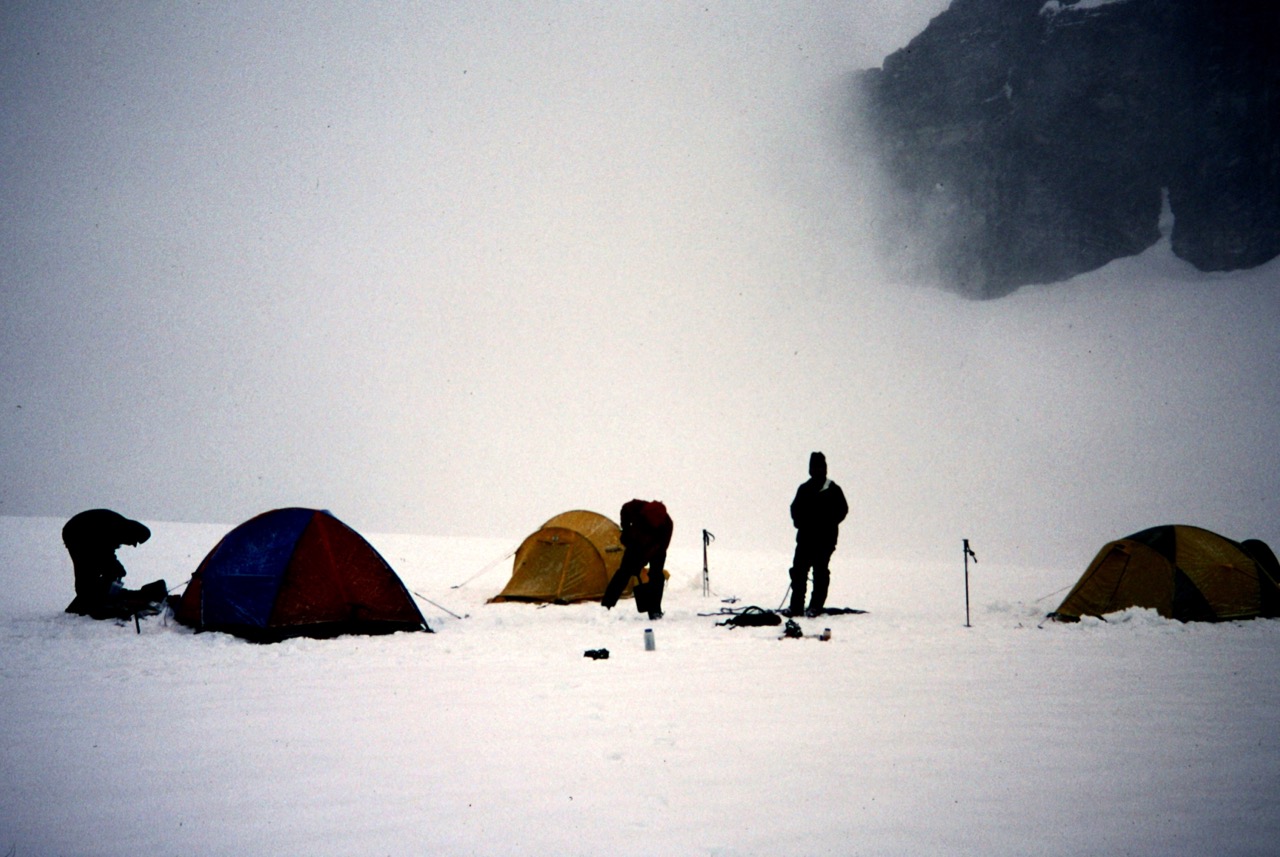 mountain climbers camp on the Klawatti Glacier in a fog bank in the McAllister Mountains