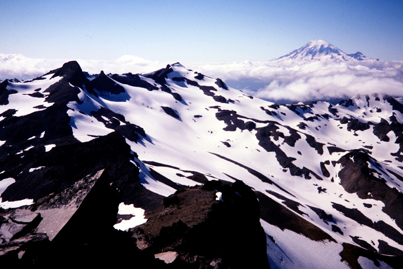 Looking across the Goat Rocks at Ives Peak and Old Snowy Mtn and Mt Rainier