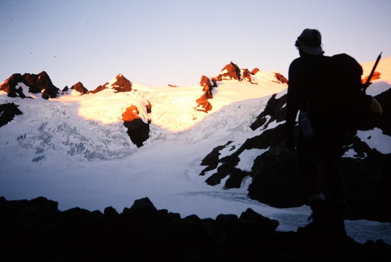 A lone climber is silhouetted against the Blue Glacier on Mt Olympus