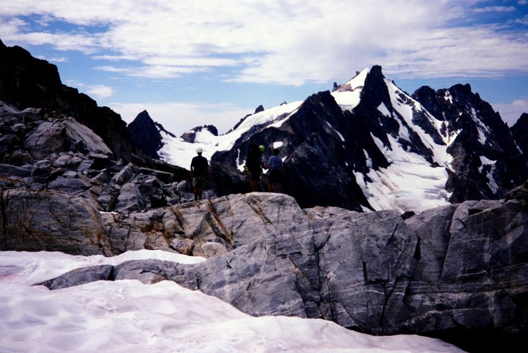 The East Peak of Mt Fury rises above a black cliff and steep glacier as seen from Luna Pass in the Picket Range