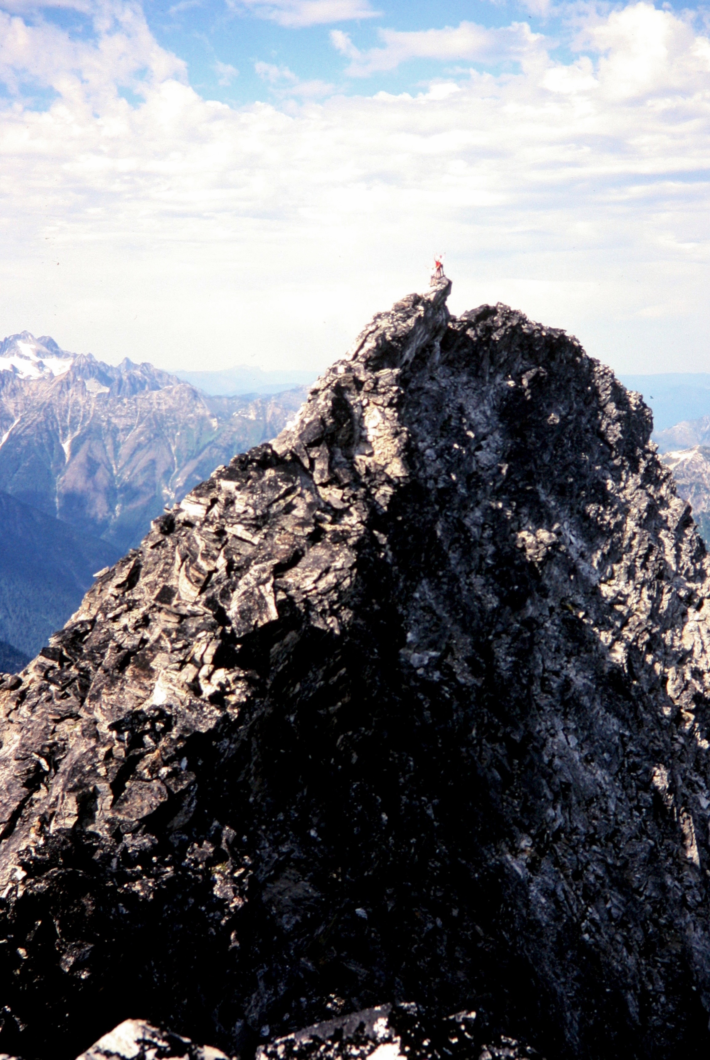 lone mountain climber on the rocky summit horn of Luna Peak in the Northern Picket Range