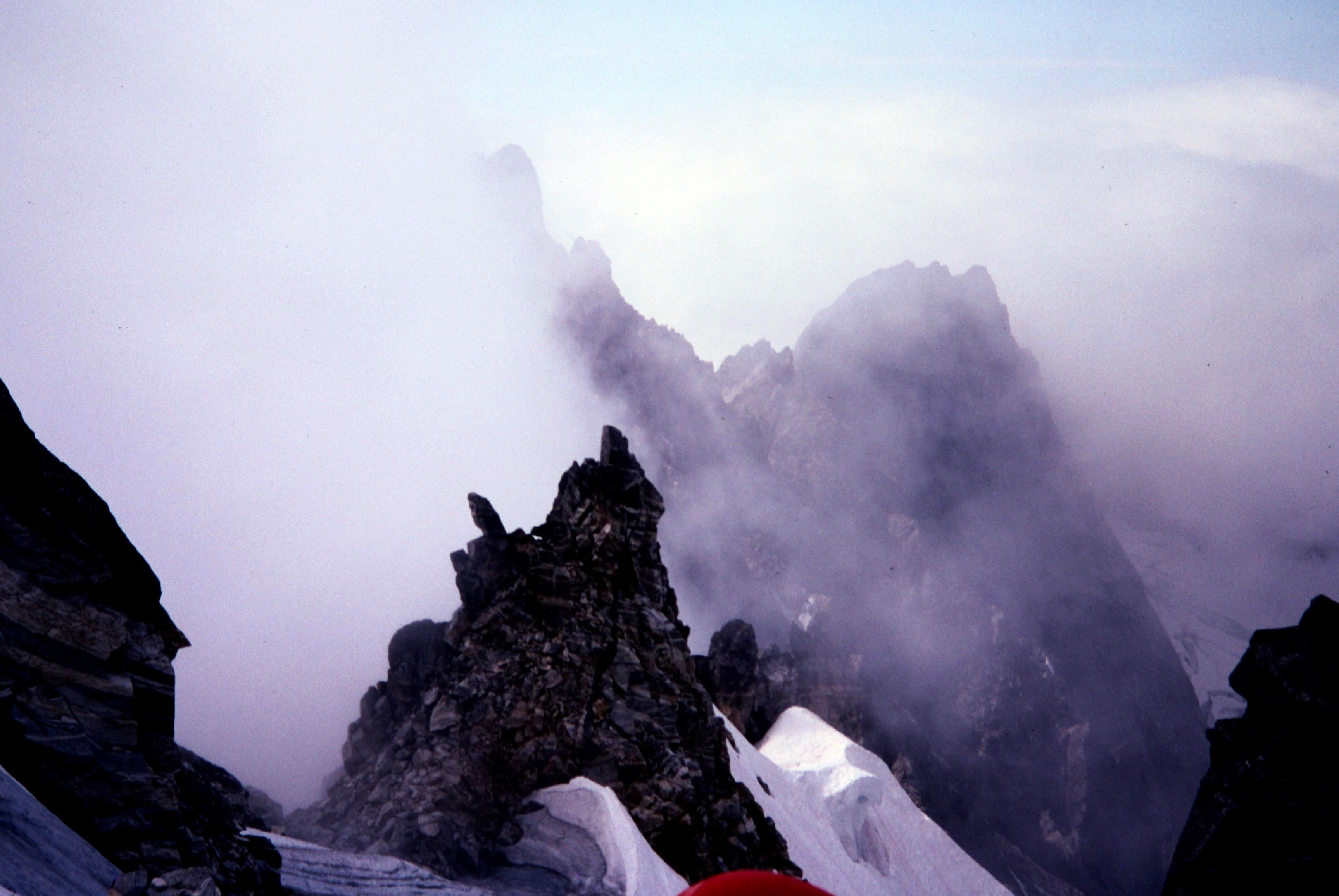 rocky horns sticking up through the clouds on the Mt Fury summit in the Northern Picket Range