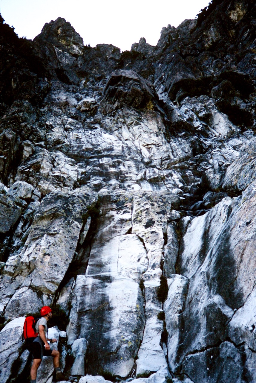 mountain climber starting to scramble up the long, rocky face of Bears Breast Mountain in the Alpine Lakes Wilderness