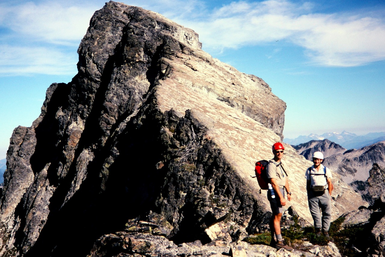 mountain climbers resting high on the rocky ridge of Bears Breast Mountain in the Alpine Lakes Wilderness