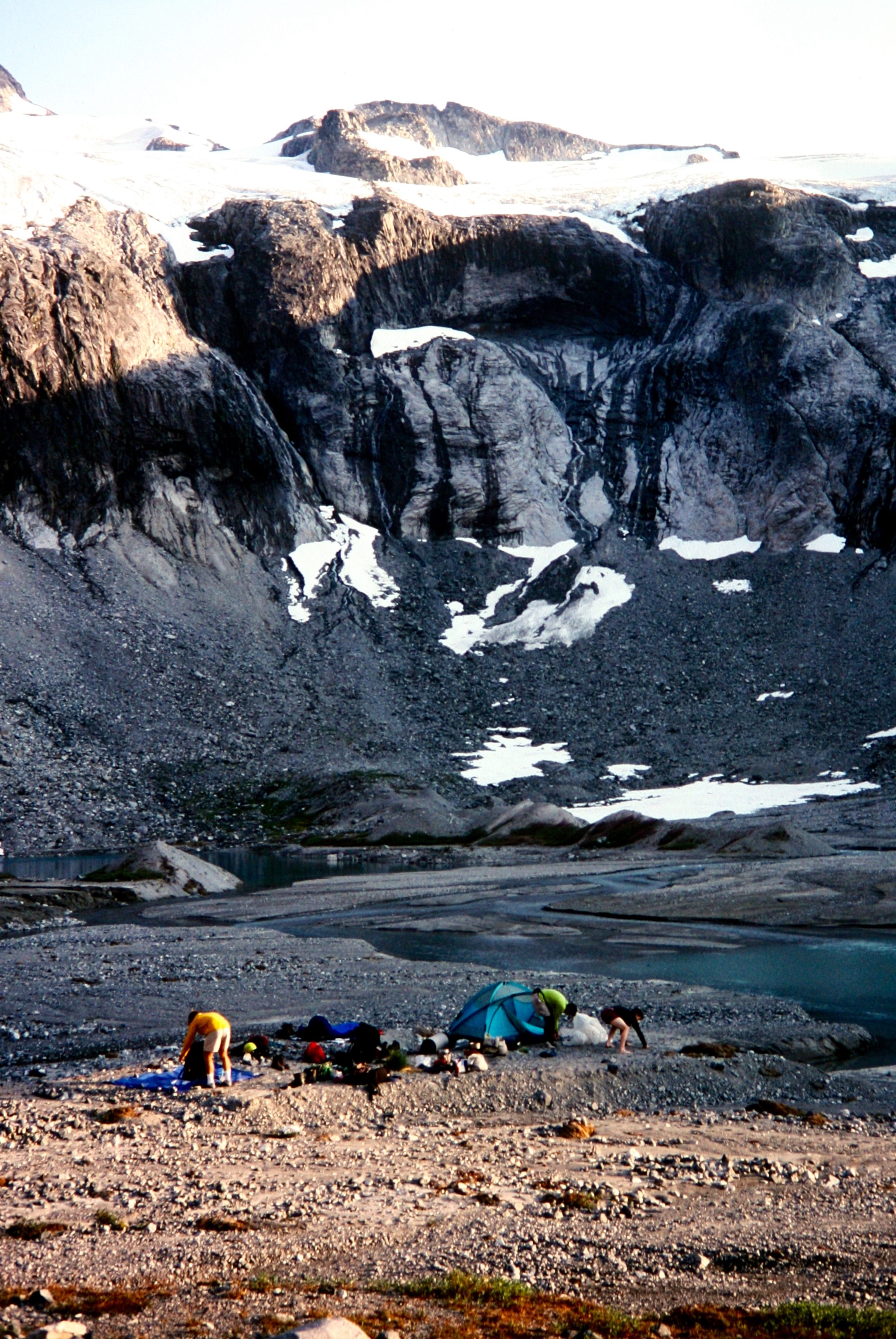 mountain climbers setting up climbers camp at Ouzel Lake in the American Chilliwack Mountains
