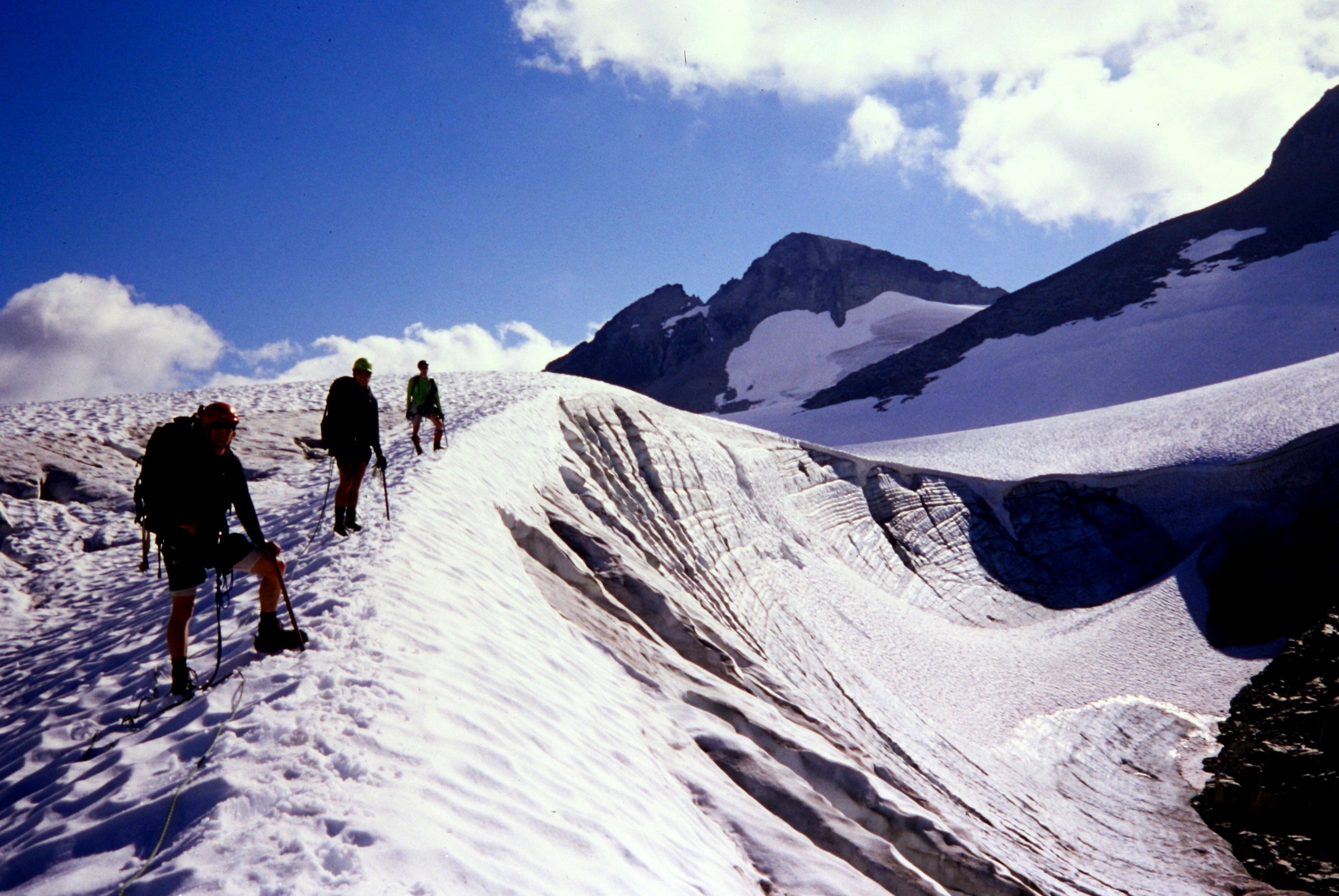 mountain climbers ascending snow field heading to Mt Redoubt in the American Chilliwack Mountains