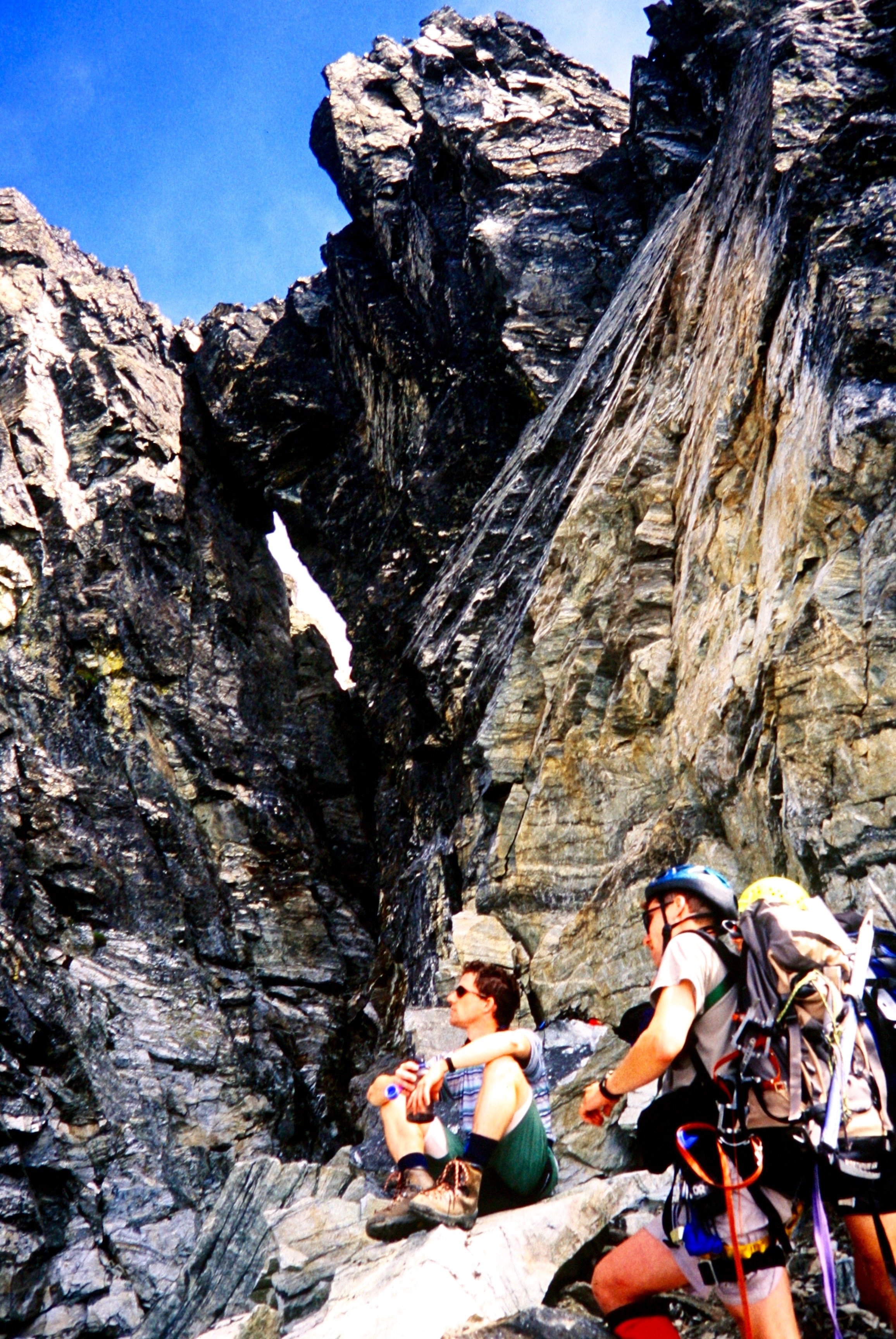 mountain climbers at the bottom of the Chockstone Chimney on Mt Redoubt in the American Chilliwack Mountains