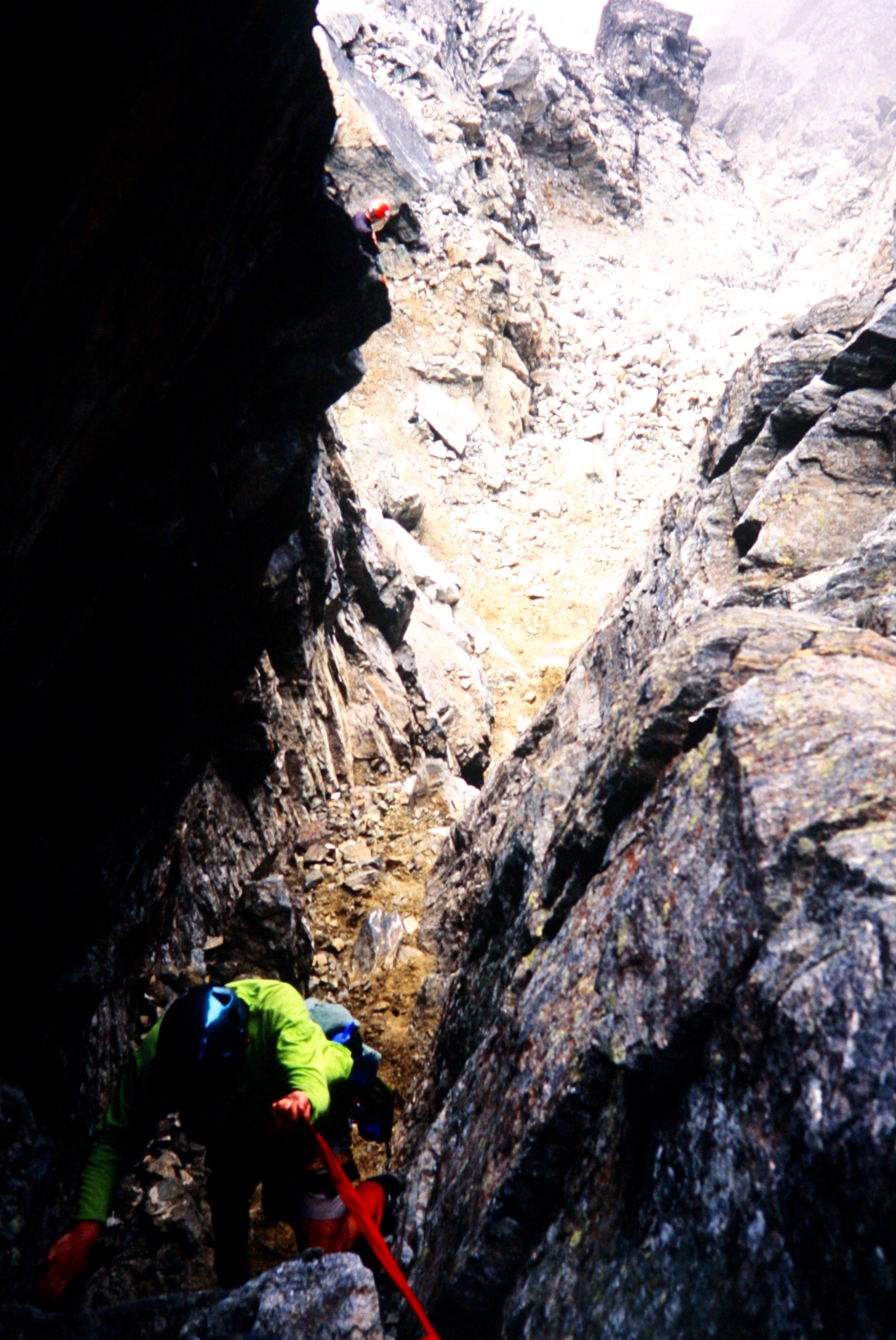 mountain climber repelling Chockstone Chimney on Mt Redoubt in the American Chilliwack Mountains