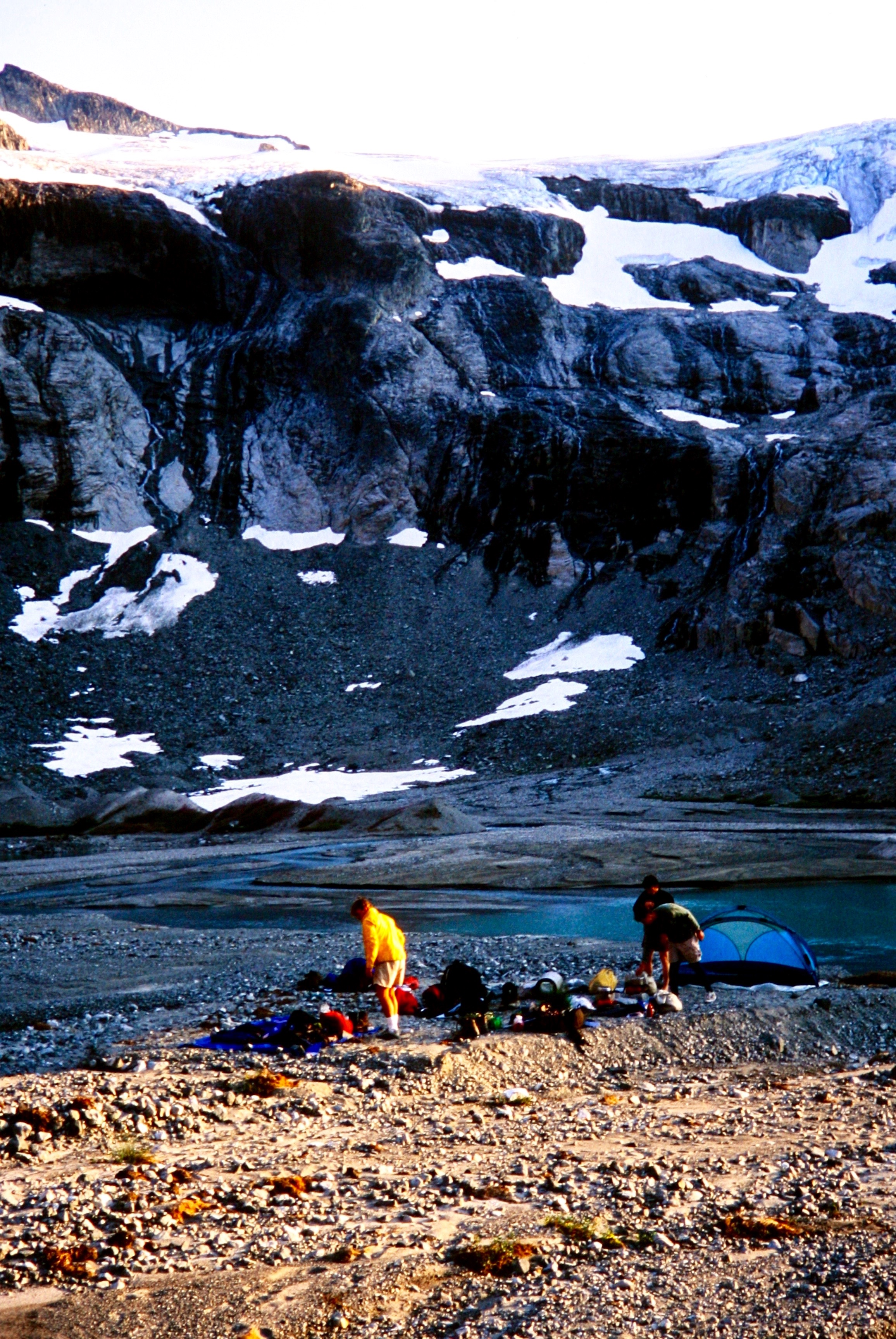 mountain climbers relaxing in Base Camp at Ouzel Lake in the American Chilliwack Mountains