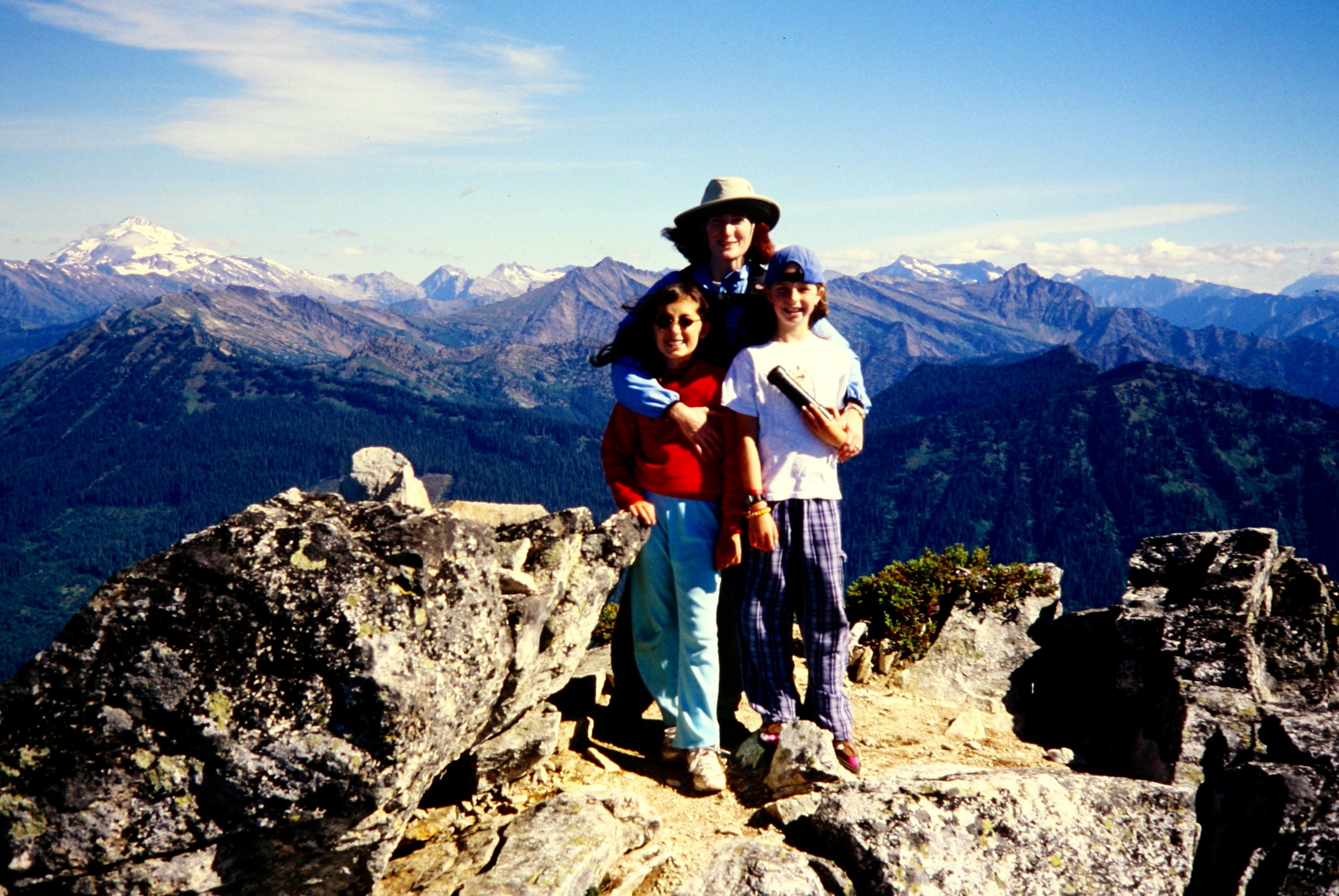 A woman and two girls pose on the summit of Labyrinth Mountain