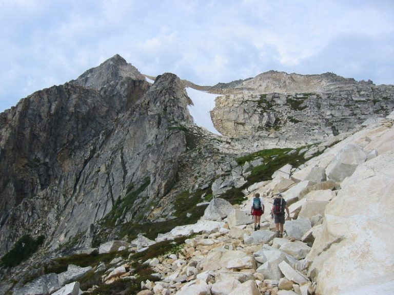 Two climbers cross a rocky slope below Mt Blum in the Lower Skagit Mountains