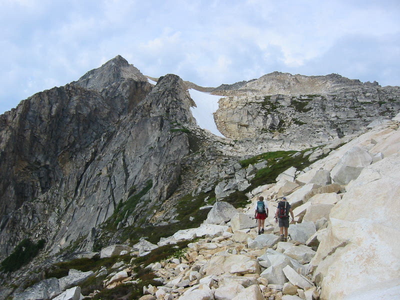 Two climbers cross a rocky slope below Mt Blum in the Lower Skagit Mountains
