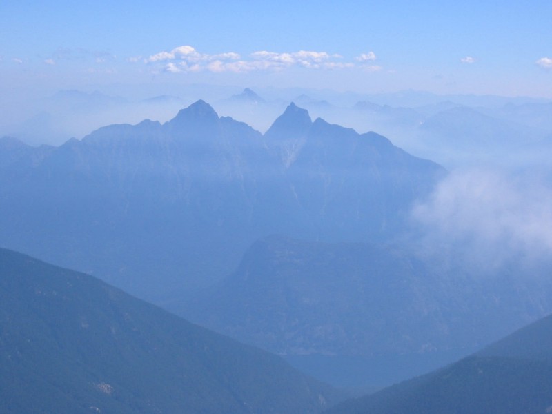 aftenoon lighting on Castle Peak which stands between Hozomeen Mountains as seen from Mt Spickard in the American Chilliwack Mountains