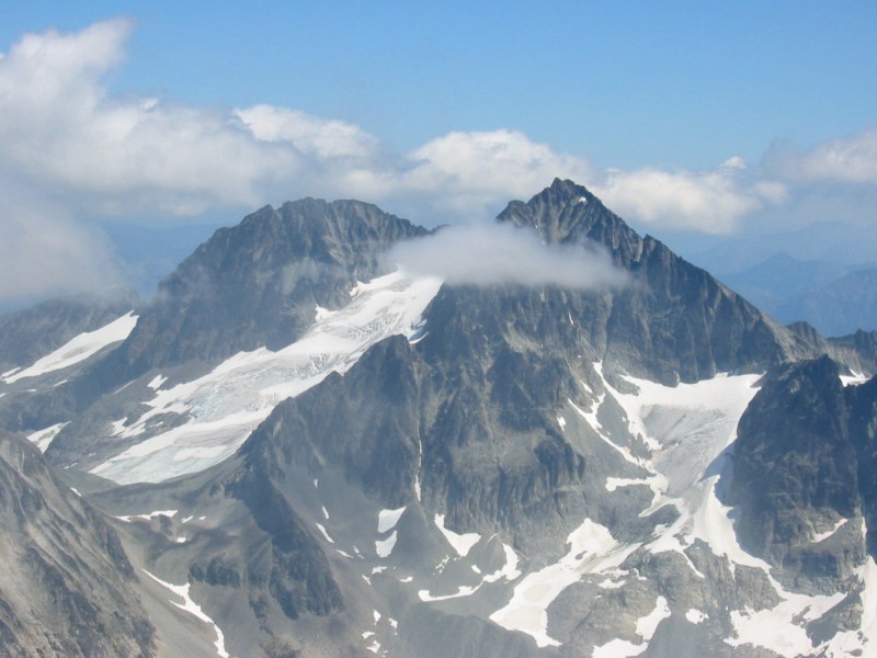 Mt Spickard with lofty clouds as seen from Mt redoubt in the American Chilliwack Mountains